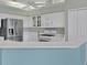 Modern white kitchen with stainless steel appliances and stone countertops at 5106 Far Oak Cir, Sarasota, FL 34238