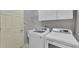 Efficient laundry room with modern washer and dryer, offering convenience and functionality at 5106 Far Oak Cir, Sarasota, FL 34238