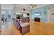 Spacious living room features hardwood floors, large windows, and a ceiling fan at 5106 Far Oak Cir, Sarasota, FL 34238