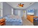 A main bedroom featuring a ceiling fan, television and ensuite bathroom at 5106 Far Oak Cir, Sarasota, FL 34238