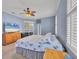 Main bedroom showing neutral carpet, a ceiling fan, and a light blue accent wall at 5106 Far Oak Cir, Sarasota, FL 34238