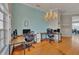 Spacious office space featuring a chandelier, hardwood floors, and natural light at 5106 Far Oak Cir, Sarasota, FL 34238