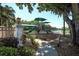 Community playground near a lake, featuring slides and play structures set amid mature trees and lush foliage at 5106 Far Oak Cir, Sarasota, FL 34238