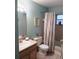 Well-lit bathroom with a vanity, toilet, and shower-tub combination with a pastel curtain at 5400 26Th W St # F104, Bradenton, FL 34207
