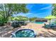 Community pool area with spa, pool, umbrella-covered tables and bar with bbq's at 5400 26Th W St # F104, Bradenton, FL 34207