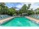 A refreshing community pool surrounded by greenery with plenty of space for relaxation at 5400 26Th W St # F104, Bradenton, FL 34207