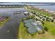 Stunning aerial view of waterfront homes, marina, and well-maintained tennis courts at 5402 Tidewater Preserve Blvd, Bradenton, FL 34208