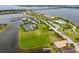 Aerial view showcasing waterfront property, tennis courts, and marina at 5402 Tidewater Preserve Blvd, Bradenton, FL 34208