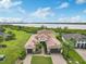 Beautiful waterfront home with a spacious lawn, lush landscaping, and a three-car garage at 5402 Tidewater Preserve Blvd, Bradenton, FL 34208