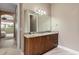 Bathroom with granite countertop, vanity, and tile floor; with an open doorway to the rest of the house at 5402 Tidewater Preserve Blvd, Bradenton, FL 34208