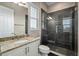Modern bathroom boasting granite countertops, under mount sink, tiled shower, and a large window at 5402 Tidewater Preserve Blvd, Bradenton, FL 34208