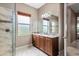 Bathroom featuring a vanity with granite countertop, tiled floors, and glass shower with tile surround at 5402 Tidewater Preserve Blvd, Bradenton, FL 34208