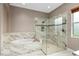 Luxurious bathroom featuring a soaking tub, glass-enclosed shower, and elegant marble finishes at 5402 Tidewater Preserve Blvd, Bradenton, FL 34208