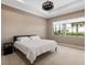 Bedroom with neutral carpet, tray ceiling, and a large window with water view at 5402 Tidewater Preserve Blvd, Bradenton, FL 34208