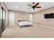 Spacious bedroom with neutral colors, a ceiling fan, and a large window with natural light at 5402 Tidewater Preserve Blvd, Bradenton, FL 34208