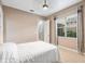 A bedroom features neutral colors and a window at 5402 Tidewater Preserve Blvd, Bradenton, FL 34208
