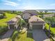 Elegant waterfront estate with manicured landscaping, and a circular paver driveway at 5402 Tidewater Preserve Blvd, Bradenton, FL 34208