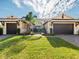 Beautiful home exterior featuring a well-manicured lawn and symmetrical garage entrances at 5402 Tidewater Preserve Blvd, Bradenton, FL 34208