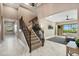 Grand foyer featuring a staircase, high ceilings, tile floors, and an open floor plan at 5402 Tidewater Preserve Blvd, Bradenton, FL 34208