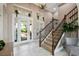 Elegant foyer featuring a staircase, high ceilings, and beautiful tile floors at 5402 Tidewater Preserve Blvd, Bradenton, FL 34208