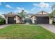 Beautiful home features a well manicured lawn, lush landscaping and a two car garage at 5402 Tidewater Preserve Blvd, Bradenton, FL 34208