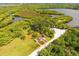 A small clearing hosts kayaks and beach furniture near a waterway at 5402 Tidewater Preserve Blvd, Bradenton, FL 34208