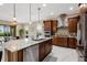 Modern kitchen featuring a large island with granite countertops and stainless steel appliances at 5402 Tidewater Preserve Blvd, Bradenton, FL 34208