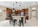 Modern kitchen featuring stainless steel appliances, an island with seating, and tiled backsplash at 5402 Tidewater Preserve Blvd, Bradenton, FL 34208