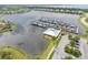 An aerial view shows the community marina and boat dock along the water's edge at 5402 Tidewater Preserve Blvd, Bradenton, FL 34208