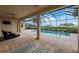 Covered outdoor space with views to pool and waterfront at 5402 Tidewater Preserve Blvd, Bradenton, FL 34208