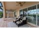 Comfortable outdoor patio with plush seating and views of the pool and backyard at 5402 Tidewater Preserve Blvd, Bradenton, FL 34208