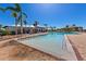 Resort-style pool area with palm trees, lounge chairs, and elegant clubhouse at 5402 Tidewater Preserve Blvd, Bradenton, FL 34208