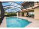 Beautiful pool area with brick pavers, a screened enclosure, and comfortable seating to enjoy the outdoors at 5402 Tidewater Preserve Blvd, Bradenton, FL 34208