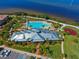 An aerial view shows the community pool, clubhouse, playground, and parking area at 5402 Tidewater Preserve Blvd, Bradenton, FL 34208
