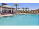 Beautiful swimming pool with an elegant clubhouse and sun loungers at 5402 Tidewater Preserve Blvd, Bradenton, FL 34208