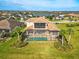 Expansive home featuring a screened pool, lush landscaping, and a tranquil water view at 5402 Tidewater Preserve Blvd, Bradenton, FL 34208