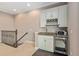 Second floor wet bar equipped with cabinets, sink, wine rack, microwave, and beverage refrigerator at 5402 Tidewater Preserve Blvd, Bradenton, FL 34208