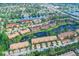 Aerial view of a waterfront community with lush tropical landscaping and stunning water features at 5736 Ashton Lake Dr # 8, Sarasota, FL 34231