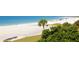 Beautiful beach vista featuring white sand, turquoise water, and lush greenery at 5736 Ashton Lake Dr, Sarasota, FL 34231