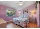 Floral bedroom with a plush bed and bedside tables at 5736 Ashton Lake Dr, Sarasota, FL 34231