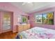 Bedroom with a large dresser, a large window, and a private door at 5736 Ashton Lake Dr, Sarasota, FL 34231