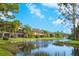 Waterfront condominiums feature lush landscaping and fountains on a sunny day at 5736 Ashton Lake Dr, Sarasota, FL 34231
