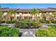 Beautiful condo exterior featuring lush landscaping and manicured bushes, creating an inviting curb appeal at 5736 Ashton Lake Dr, Sarasota, FL 34231