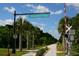 Scenic view of Legacy Trail with tall palm trees, blue skies and bright signage at 5736 Ashton Lake Dr, Sarasota, FL 34231