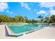 Community swimming pool surrounded by palm trees, featuring crystal clear blue water at 5736 Ashton Lake Dr, Sarasota, FL 34231
