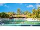 Community swimming pool with abundant lounge chairs and a building in the background at 5736 Ashton Lake Dr, Sarasota, FL 34231