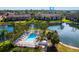 Aerial view of the community pool surrounded by lush landscaping and a tranquil lake at 5736 Ashton Lake Dr, Sarasota, FL 34231
