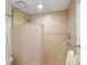 Walk-in shower featuring neutral tilework and glass partition at 5736 Ashton Lake Dr, Sarasota, FL 34231
