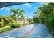 Community shuffleboard courts surrounded by tropical landscaping and a serene waterfront view at 5736 Ashton Lake Dr, Sarasota, FL 34231