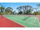 Community tennis court with lush landscaping providing shade on a sunny day at 5736 Ashton Lake Dr, Sarasota, FL 34231